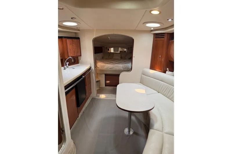Slide: The Image of Interior of 2002 Sea Ray 360 Sundancer yacht with kitchen and seating area. - 14