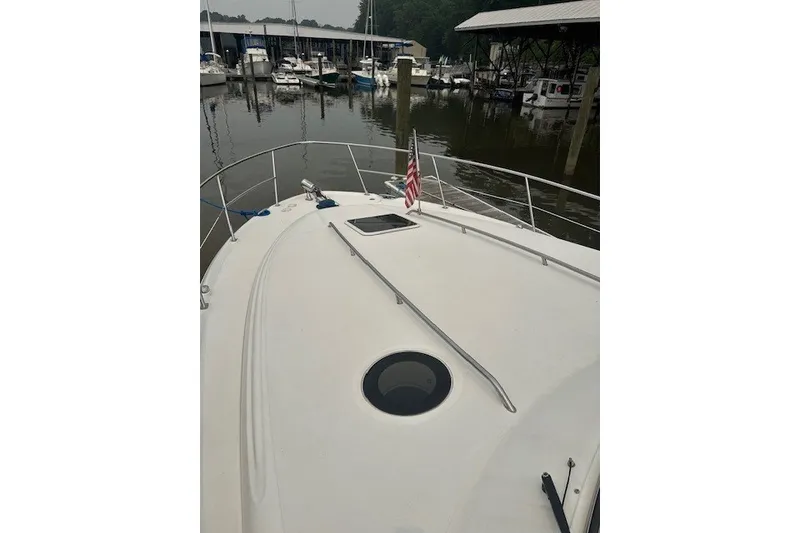 Slide: The Image of 2002 Sea Ray 360 Sundancer yacht docked at marina with American flag. - 3