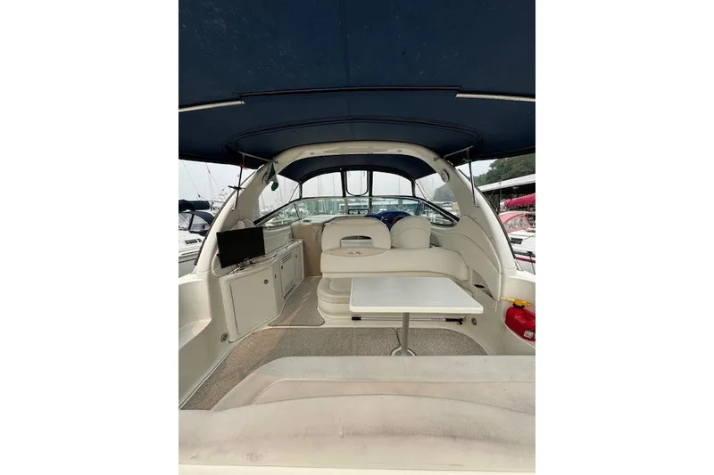 Slide: The Image of Interior view of a 2002 Sea Ray 360 Sundancer yacht with seating and table. - 8