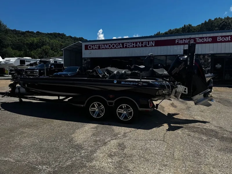 The Image of A black 2021 Ranger Z521L boat on a trailer in front of a fishing tackle shop. - 1