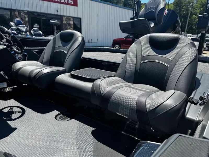 Slide: The Image of The image shows two black, cushioned seats in a boat, surrounded by accessories. - 7