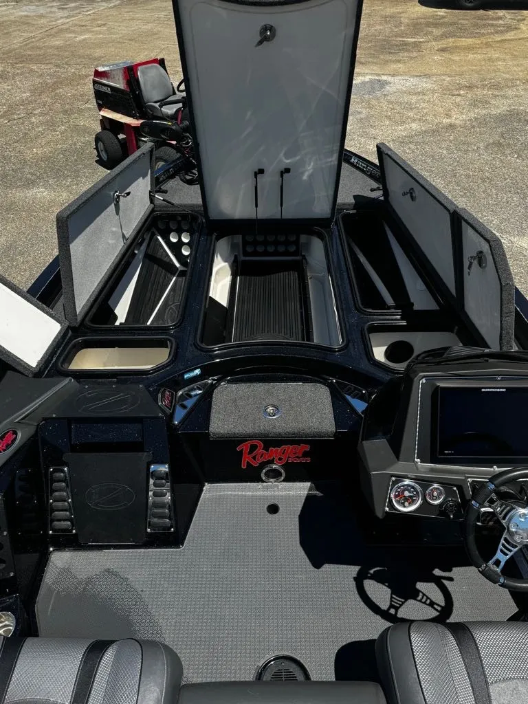 Slide: The Image of The image shows the cockpit of a 2021 Ranger Z521L boat with open storage compartments. - 4