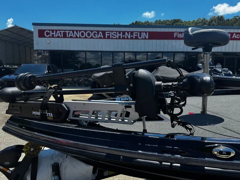 Slide: The Image of A 2021 Ranger Z521L boat with a Minn Kota trolling motor, parked in front of a store. - 5