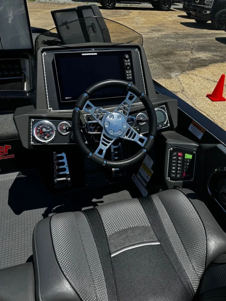 Slide: The Image of The image shows the cockpit of a 2021 Ranger Z521L boat with a modern steering wheel and instruments. - 3