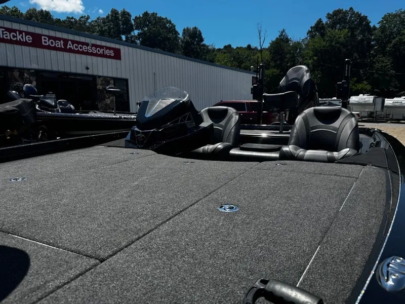Slide: The Image of A 2021 Ranger Z521L with gray carpeting and black seats, parked in front of a store. - 13
