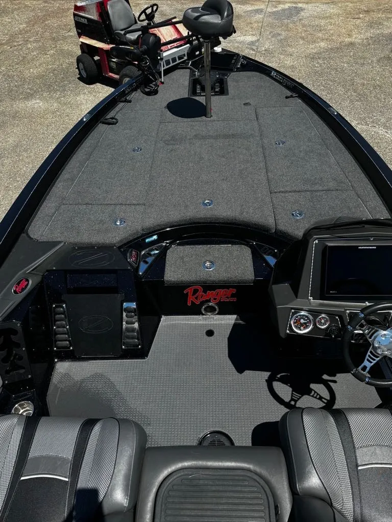 Slide: The Image of The image shows the cockpit of a 2021 Ranger Z521L boat with gray upholstery and a helm station. - 8