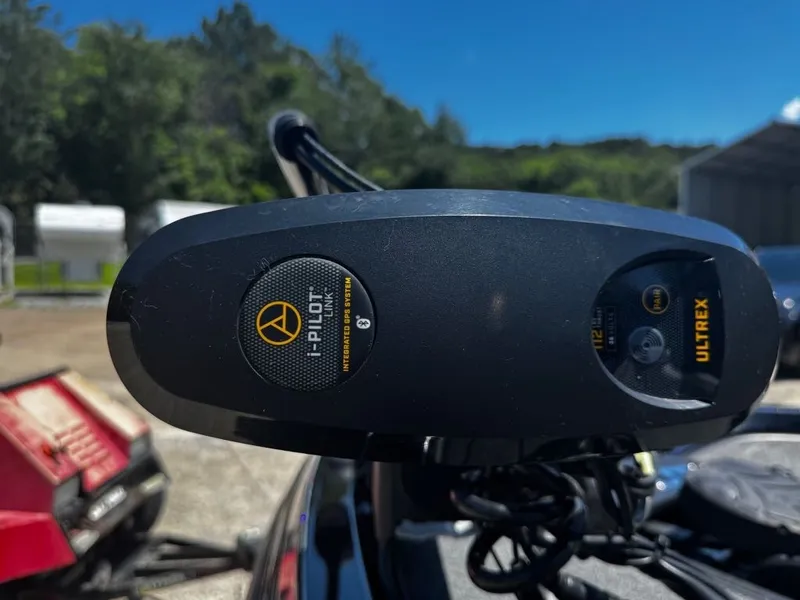 Slide: The Image of Close-up of an i-Pilot Ultrex motor on a Ranger boat, surrounded by trees and buildings. - 12