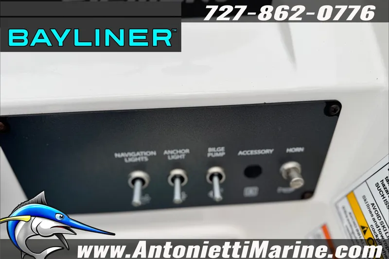 Slide: The Image of Control panel of a 2021 Bayliner Element E21 boat with switches and branding. - 21