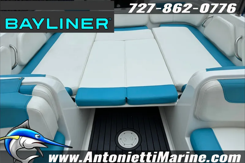 Slide: The Image of 2021 Bayliner Element E21 boat interior with blue and white seating, Antonietti Marine branding. - 17