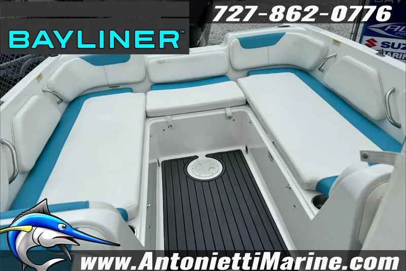 Slide: The Image of 2021 Bayliner Element E21 boat interior with white and blue seating, showcased by Antonietti Marine. - 23