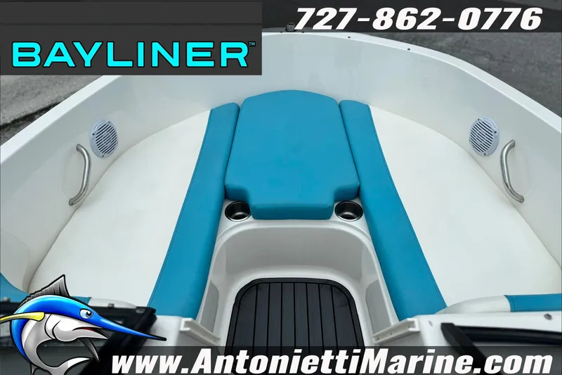 Slide: The Image of 2021 Bayliner Element E21 boat interior with blue seating, cup holders, and speakers. - 13