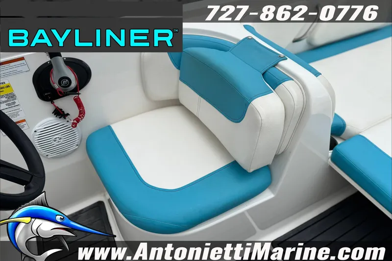 Slide: The Image of 2021 Bayliner Element E21 boat interior with blue and white seating, steering wheel, and controls. - 18