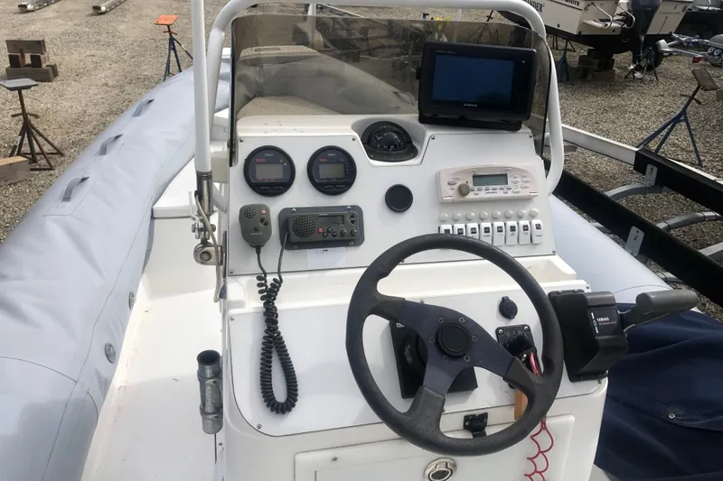 Slide: The Image of Control panel of a 2003 Nautica 22 Wide Body boat with steering wheel and instruments. - 15