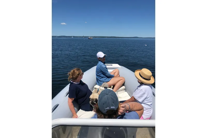 Slide: The Image of People relaxing on a 2003 Nautica 22 Wide Body boat, enjoying a sunny day on the water. - 13