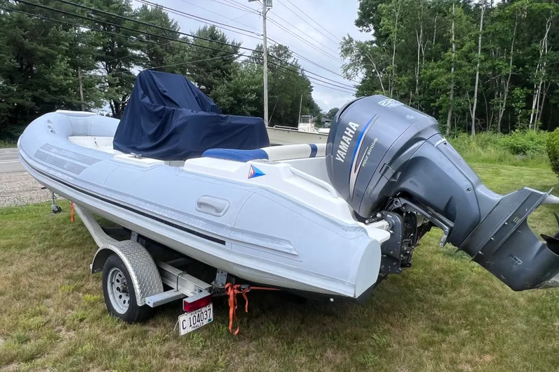 Slide: The Image of 2003 Nautica 22 Wide Body boat with Yamaha engine on trailer, parked on grass. - 8