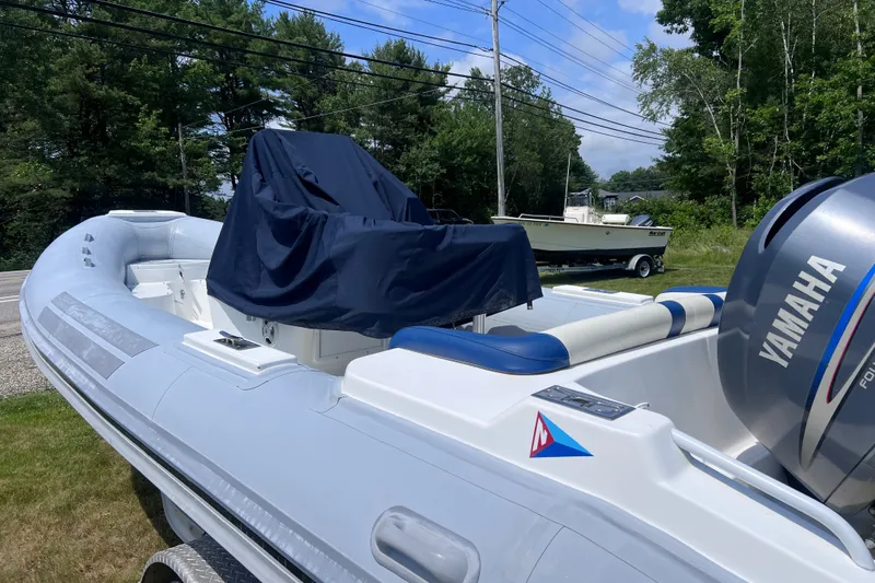 Slide: The Image of 2003 Nautica 22 Wide Body boat with Yamaha engine, parked outdoors. - 2