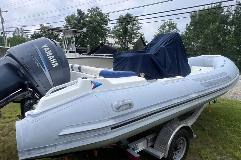 Slide: The Image of 2003 Nautica 22 Wide Body boat with Yamaha engine on trailer, parked outdoors. - 6