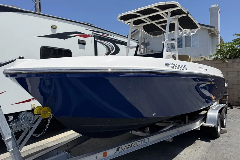 Slide: The Image of 2022 Bayliner Trophy T22CX boat on trailer, parked outdoors. - 9