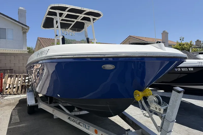 Slide: The Image of 2022 Bayliner Trophy T22CX boat on trailer, parked in residential driveway. - 10