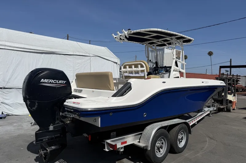 Slide: The Image of 2022 Bayliner Trophy T22CX boat with Mercury engine on trailer, parked outdoors. - 5