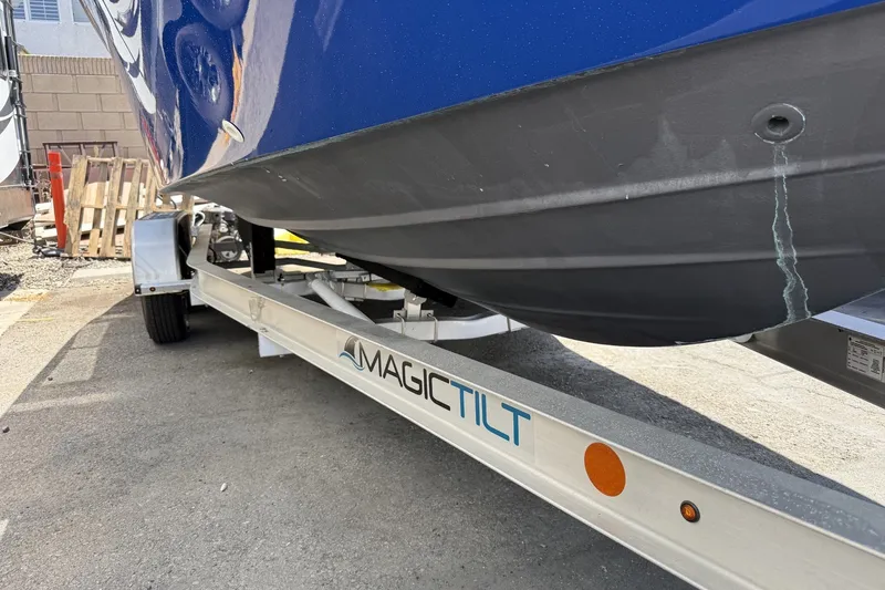 Slide: The Image of 2022 Bayliner Trophy T22CX boat on Magic Tilt trailer, side view. - 7