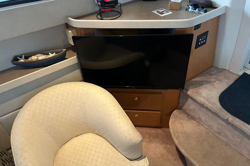 Slide: The Image of Interior of 2001 Regal Commodore 3780 yacht with TV, chair, and decorative items. - 7