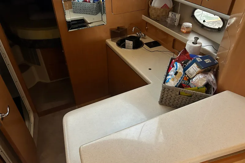 Slide: The Image of Interior of 2001 Regal Commodore 3780 yacht with kitchen area and storage basket. - 6