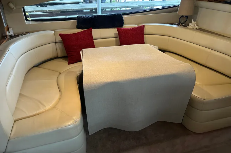 Slide: The Image of Luxurious interior of 2001 Regal Commodore 3780 yacht with cream leather seating and red cushions. - 9