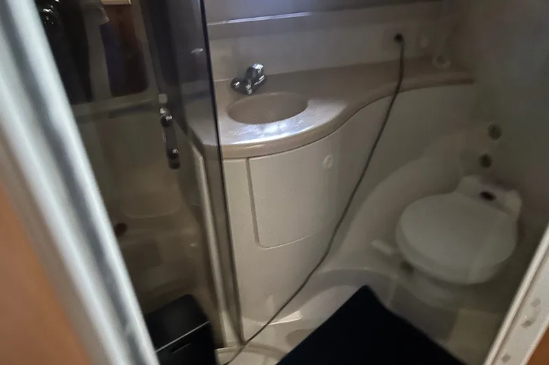 Slide: The Image of Bathroom interior of 2001 Regal Commodore 3780 yacht, featuring sink and toilet. - 5