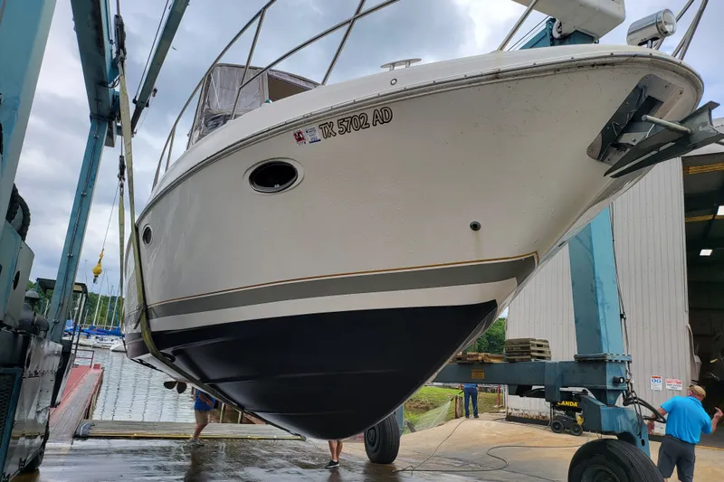Slide: The Image of 2001 Regal Commodore 3780 boat being lifted at a marina dock. - 2