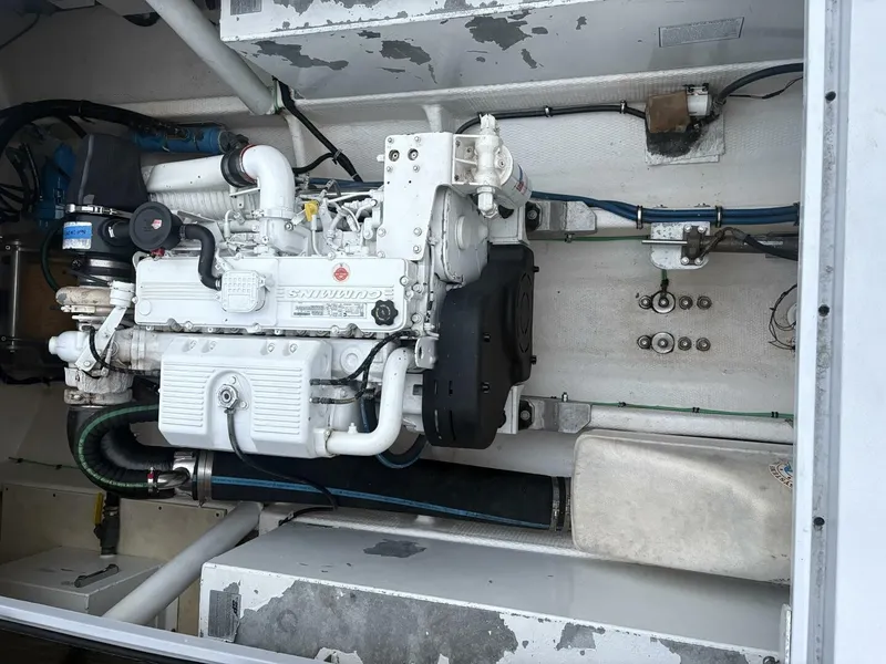 Slide: The Image of A clean engine compartment with a white engine and various pipes and cables. - 17