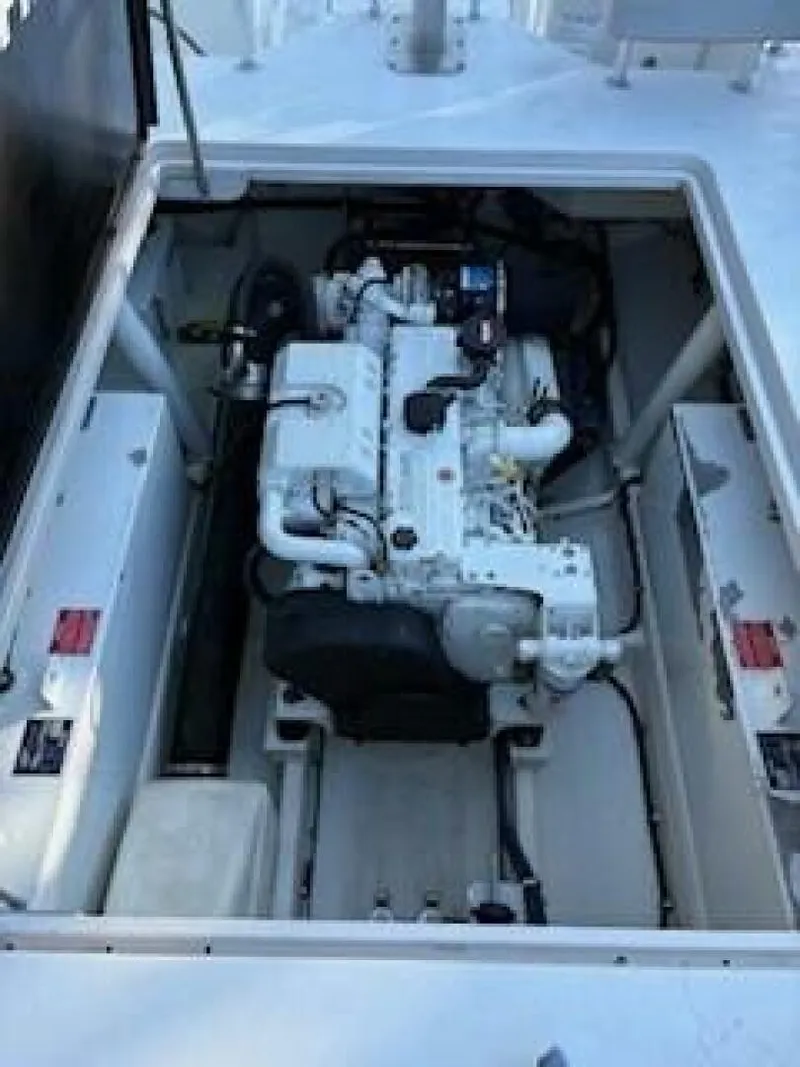 Slide: The Image of A clean engine compartment with a white engine, surrounded by white walls and cables. - 13