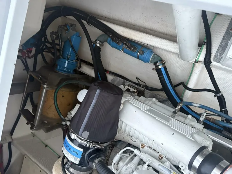 Slide: The Image of The engine compartment of a 2015 OceanPro 35 boat shows engine and hoses. - 16