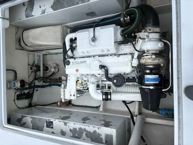 Slide: The Image of A clean engine compartment with a white engine and various pipes and hoses. - 15