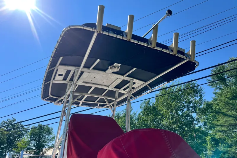 Slide: The Image of Boston Whaler 240 Outrage 2004 boat with T-top under clear blue sky. - 14