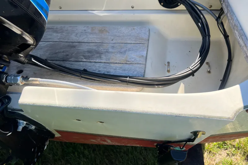 Slide: The Image of 1973 Boston Whaler 19 Outrage boat interior with motor and wiring details. - 22