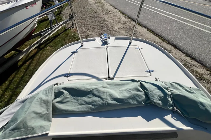 Slide: The Image of 1973 Boston Whaler 19 OUTRAGE boat deck with cover, parked on roadside. - 10
