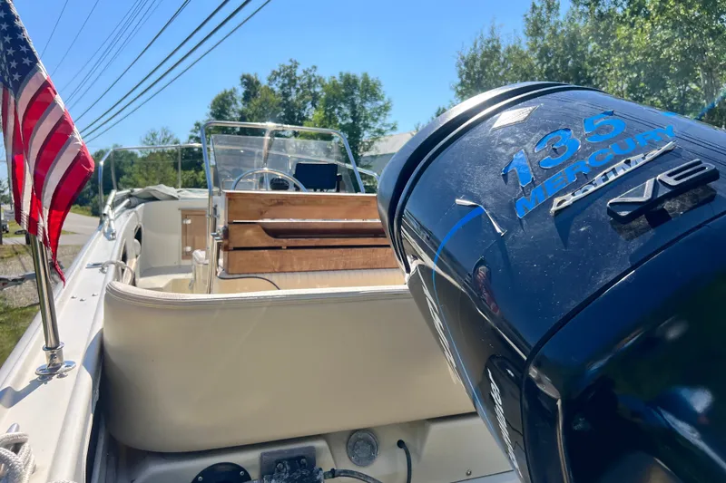 Slide: The Image of 1973 Boston Whaler 19 Outrage boat with Mercury 135 engine and American flag. - 27