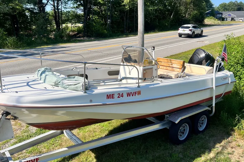 Slide: The Image of 1973 Boston Whaler 19 OUTRAGE boat on trailer by roadside, sunny day. - 2