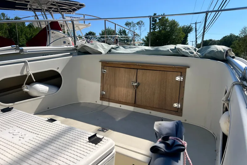 Slide: The Image of 1973 Boston Whaler 19 Outrage boat interior with storage compartment and seating area. - 16