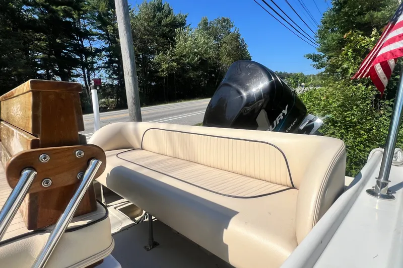 Slide: The Image of 1973 Boston Whaler 19 OUTRAGE boat with Mercury engine and American flag. - 20