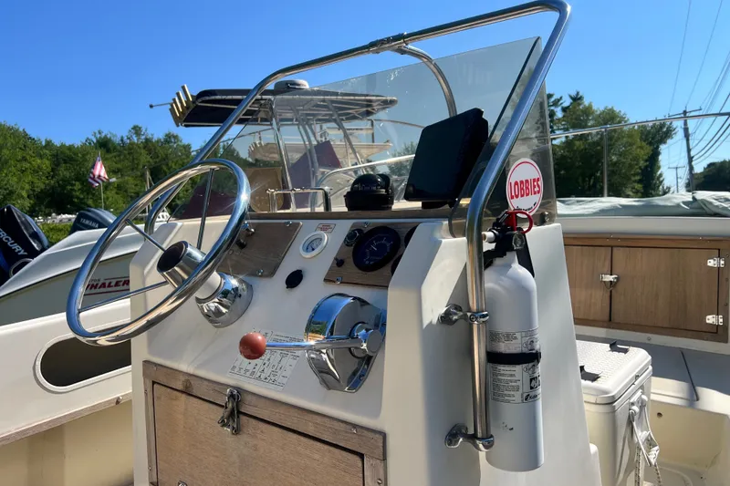 Slide: The Image of 1973 Boston Whaler 19 Outrage boat console with steering wheel and controls. - 15