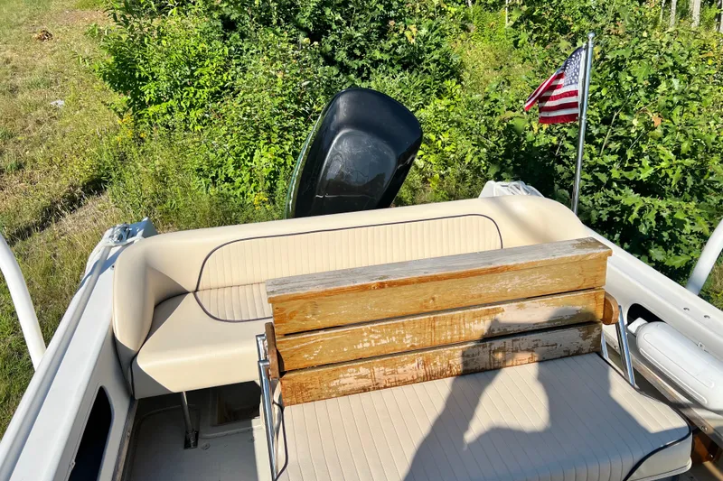 Slide: The Image of 1973 Boston Whaler 19 Outrage boat interior with American flag and outboard motor. - 9