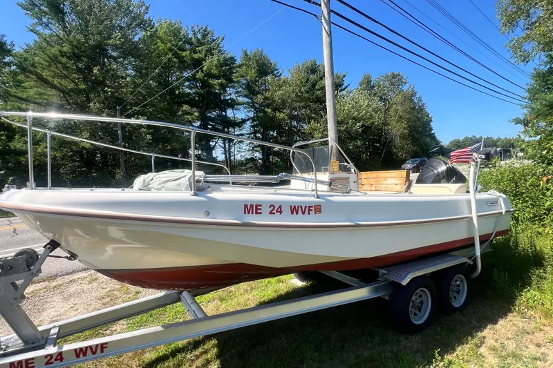 Slide: The Image of 1973 Boston Whaler 19 Outrage boat on trailer, parked outdoors, sunny day. - 28