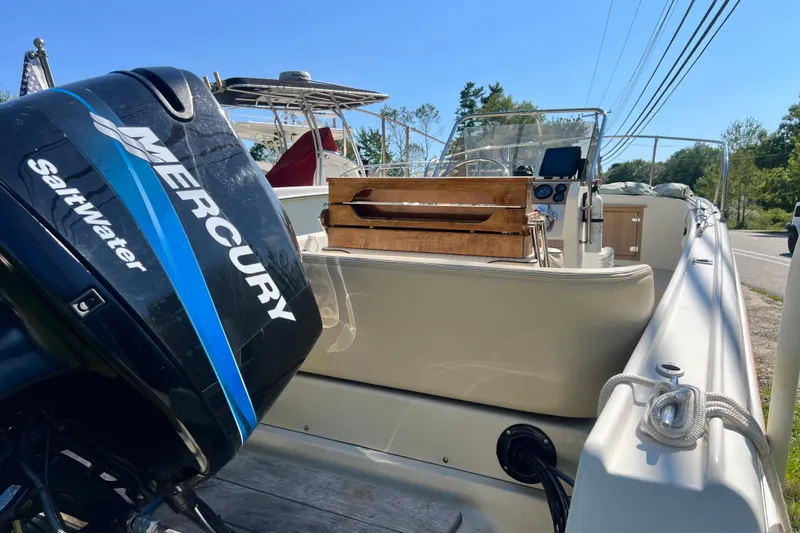 Slide: The Image of 1973 Boston Whaler 19 Outrage boat with Mercury Saltwater engine, docked outdoors. - 11