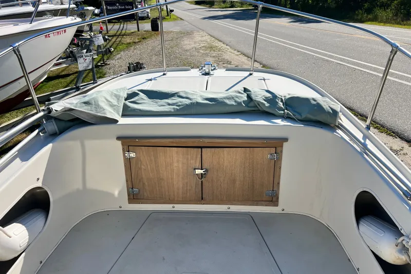 Slide: The Image of 1973 Boston Whaler 19 Outrage boat interior with wooden storage compartment. - 8