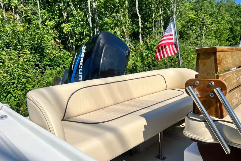 Slide: The Image of 1973 Boston Whaler 19 Outrage boat interior with Mercury engine and American flag. - 18