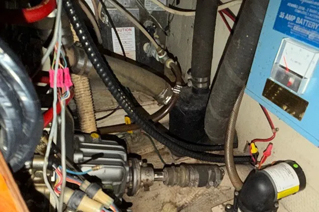 Slide: The Image of Engine compartment of a 1983 S2 9.2C sailboat with various mechanical components and wiring. - 17