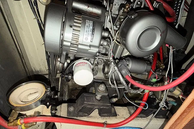 Slide: The Image of Engine compartment of a 1983 S2 9.2C sailboat with visible wiring and components. - 18