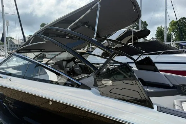 Slide: The Image of 2024 Cobalt R8 boat with sleek design, black and white exterior, and modern canopy. - 33